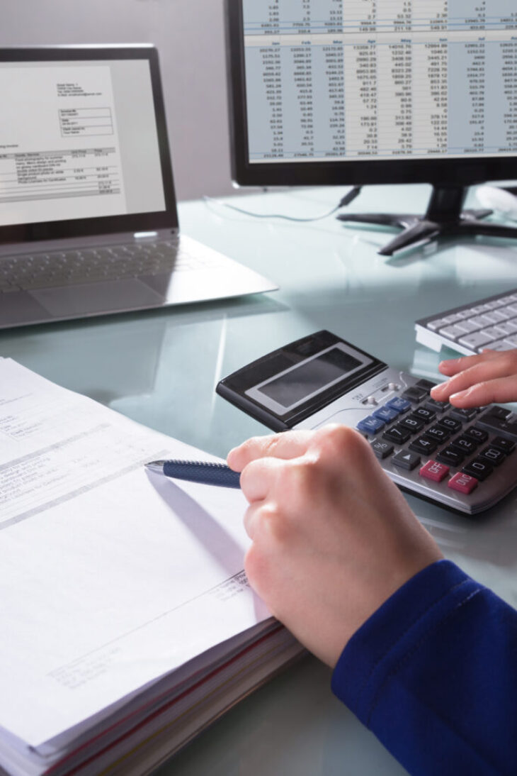 Businessperson Calculating Invoice
